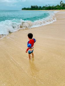 beach safety tips for kids include covering up their skin and having them wear floats when going into the water.